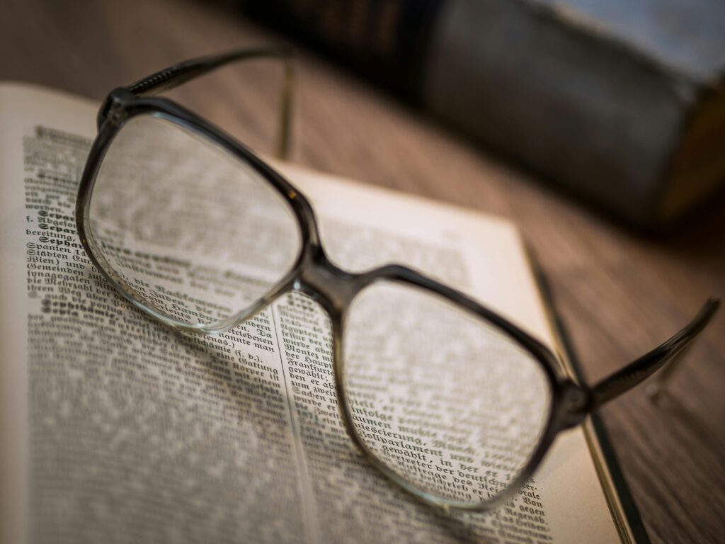 Blurry eyeglass in a book